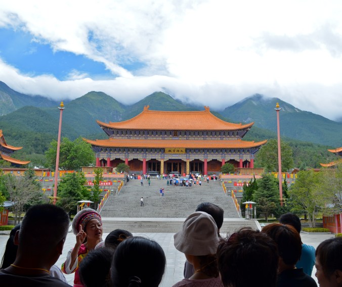 Typical Chinese tour group. Huge heard of people following someone dressed in ethnic attire. 