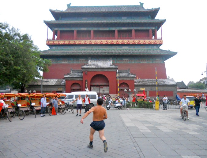 A man prepares to kick a jianzi, or Chinese hacky sack, in front of the Drum Tower. 